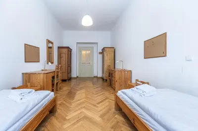 a room with two beds and wooden furniture in it at Jiriho z Podebrad Apartments in Prague
