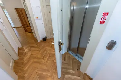 a hallway with a door and a wooden floor at Jiriho z Podebrad Apartments in Prague