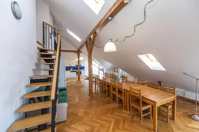 a dining room with a long table and chairs at Jiriho z Podebrad Apartments in Prague