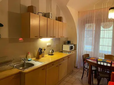 a kitchen with a sink and a microwave and a table at 1 Bed Flat - Sleeps 3 - Pets - Wifi in Prague