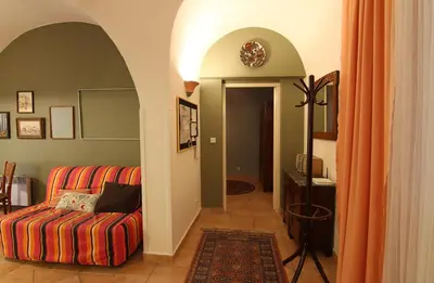 a living room with a couch and an archway at 1 Bed Flat - Sleeps 3 - Pets - Wifi in Prague