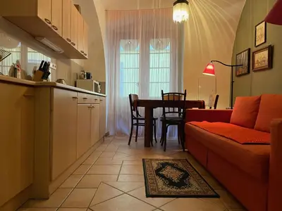 a kitchen and a living room with a couch and a table at 1 Bed Flat - Sleeps 3 - Pets - Wifi in Prague