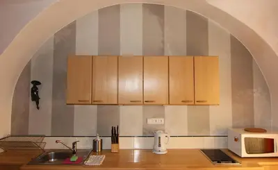 a kitchen with wooden cabinets and a counter top at 1 Bed Flat - Sleeps 3 - Pets - Wifi in Prague
