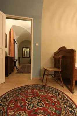 a hallway with a rug and a chair and a table at 1 Bed Flat - Sleeps 3 - Pets - Wifi in Prague