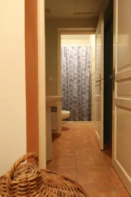 a hallway with a bathroom with a toilet and a window at 1 Bed Flat - Sleeps 3 - Pets - Wifi in Prague