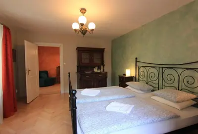 a bedroom with two beds and a chandelier at 1 Bed Flat - Sleeps 2 - Wifi in Prague