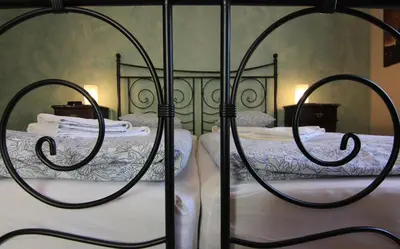two beds in a bedroom with white sheets at 1 Bed Flat - Sleeps 2 - Wifi in Prague