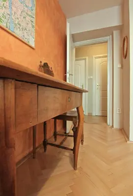 a wooden table in a room with a map on the wall at 1 Bed Flat - Sleeps 2 - Wifi in Prague
