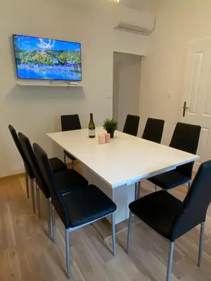 a conference room with a white table and chairs at Designed apartment next to Vaclav square with terrace and private garage in Prague
