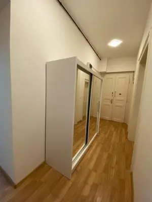 an empty room with white walls and wooden floors at Designed apartment next to Vaclav square with terrace and private garage in Prague