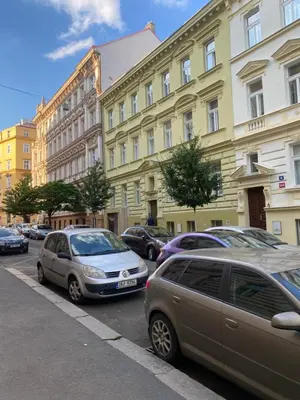 a group of cars parked in front of buildings at Designed apartment next to Vaclav square with terrace and private garage in Prague