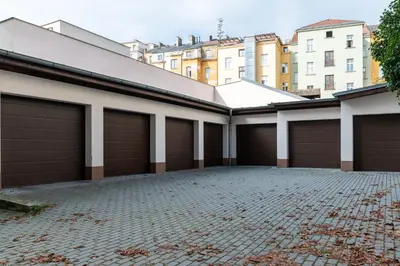 a row of garage doors on a building at Designed apartment next to Vaclav square with terrace and private garage in Prague