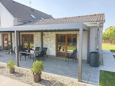 a patio with chairs and a table in a house at Ubytování U Vrbičky - blízko Prahy in Unhošť