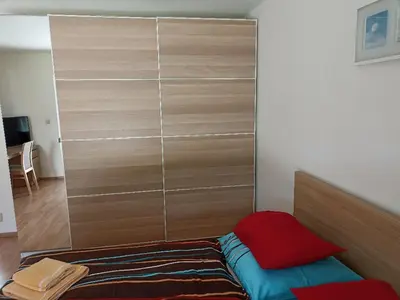 a bedroom with a large closet with a bed at Ubytování U Vrbičky - blízko Prahy in Unhošť