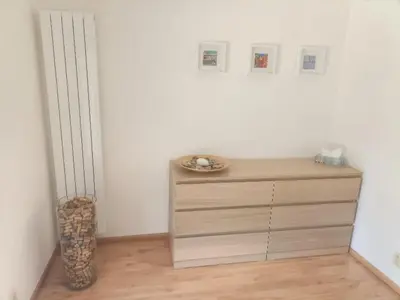 a dresser in a room with a white wall at Ubytování U Vrbičky - blízko Prahy in Unhošť