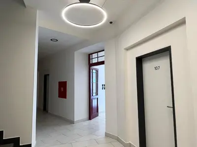 a hallway with a door and a light fixture at Figaro Suites in Prague