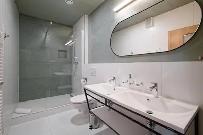 a bathroom with a sink and a shower and a toilet at Luma Terra Prague Hostel in Prague