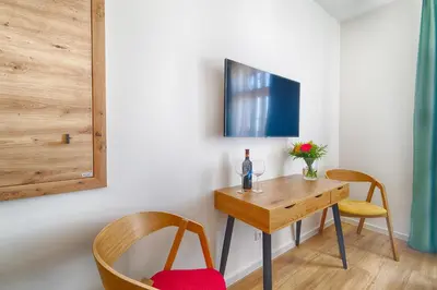 a room with a table and two chairs and a tv at Luma Terra Prague Hostel in Prague