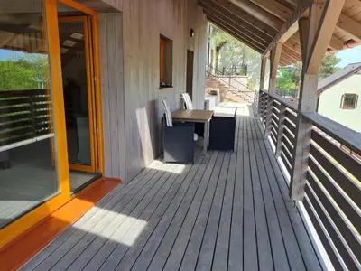 a porch of a house with a table and chairs at Chata Eliška Hrdlička, Čím u Prahy in Čím