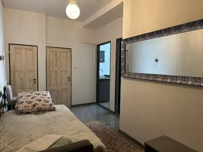 a bedroom with a bed and a large mirror at APARTMEN PRAHA in Prague