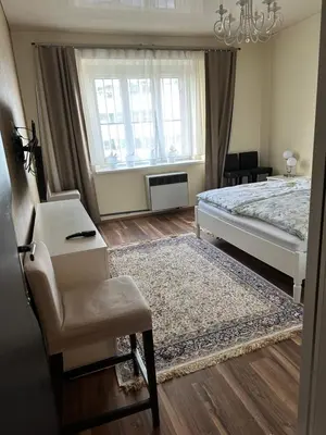 a bedroom with a bed and a chair and a desk at APARTMEN PRAHA in Prague