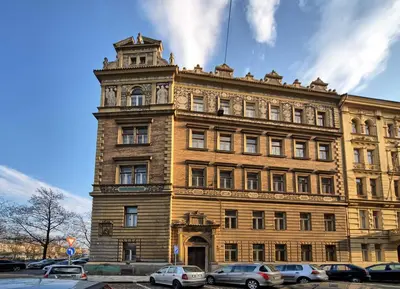 a large building with cars parked in front of it at Riverside Apartment in Prague