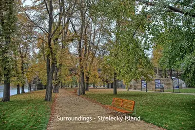 a park with a bench and trees in the park at Riverside Apartment in Prague
