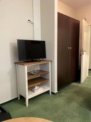 a living room with a television on a cabinet at Bechnerův statek in Lány