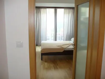 a small bedroom with a bed and a window at Garden apartment with garage in central Prague in Prague