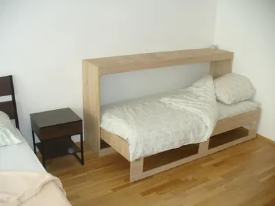 a bedroom with a bed and a mirror on the wall at Garden apartment with garage in central Prague in Prague