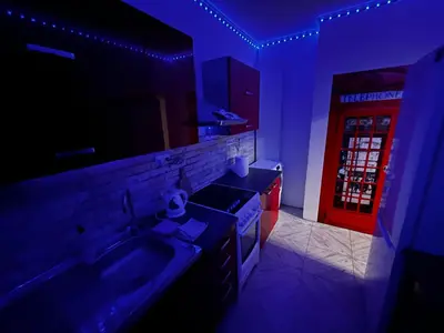 a kitchen with a sink and a red door at MONFas APARTMENT BARRANDOV in Prague