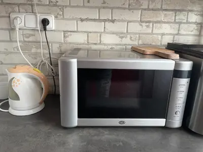 a microwave oven sitting on a counter next to a wall at MONFas APARTMENT BARRANDOV in Prague