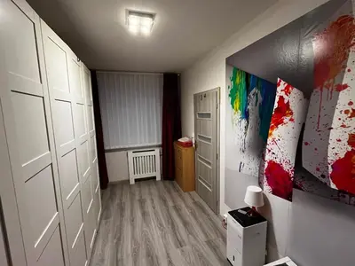 a room with a hallway with white doors and paintings at MONFas APARTMENT BARRANDOV in Prague
