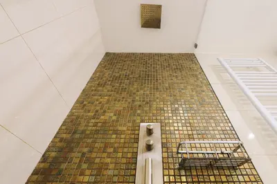 a bathroom with a tiled floor in a room at Stevan Apartment in Prague