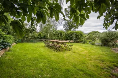 a picnic table in a field of grass at Apartmány Mind Adventure in Lštění