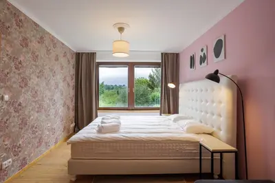 a bedroom with a large bed with a window at Apartmány Mind Adventure in Lštění