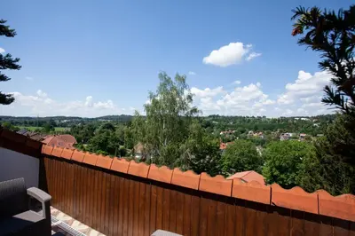 a wooden fence with a view of a city at Apartmány Mind Adventure in Lštění