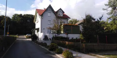 a white house on the side of a street at Hotel U Parku in Hořovice
