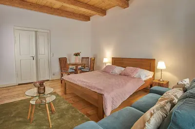 a bedroom with a bed and a couch at Jeruzalémská - Synagogue Apartments in Prague