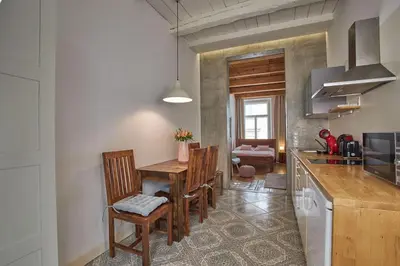 a kitchen with a table and chairs in a room at Jeruzalémská - Synagogue Apartments in Prague