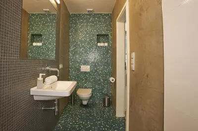 a bathroom with a sink and a toilet at Jeruzalémská - Synagogue Apartments in Prague