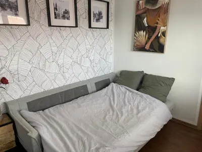a bed in a bedroom with pictures on the wall at Andel apartment with terrace in Prague