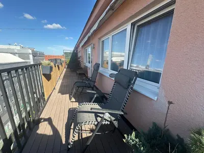 a balcony with chairs and windows on a building at Andel apartment with terrace in Prague