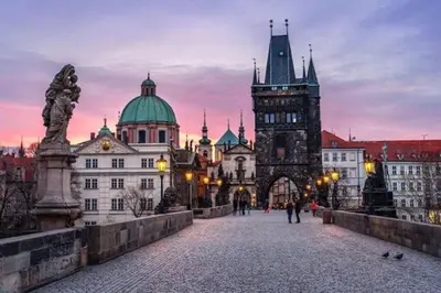 a large building with a clock tower in a city at Andel apartment with terrace in Prague