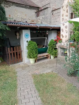 a house with a garden with a boat on the porch at Chalupa u dědy in Dlažkovice
