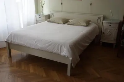 a white bed with two pillows on top of it at U Obecního dvora - LindasFlat Apartment - Old Town Prague in Prague