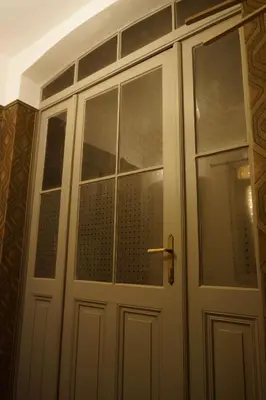 a white door with windows in a room at U Obecního dvora - LindasFlat Apartment - Old Town Prague in Prague