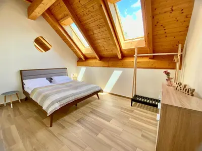 a bedroom with a bed and a wooden ceiling at Relax Apartment in Prague