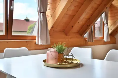 a bench in a room with a wooden ceiling at Relax Apartment in Prague