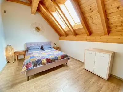a bedroom with a bed and a wooden ceiling at Relax Apartment in Prague